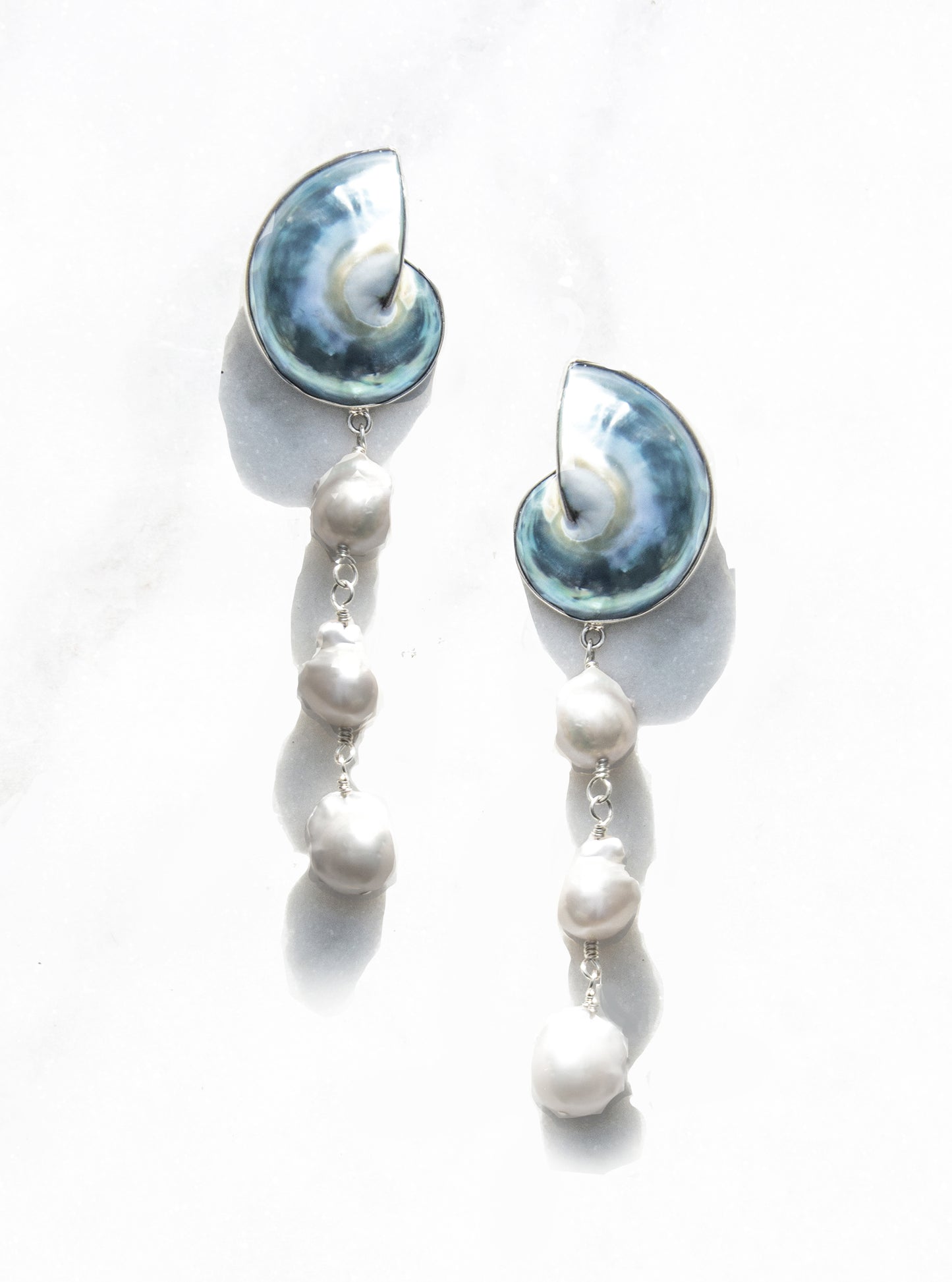 A pair of 925 Silver Encased Nautilus Shell Cascade Earrings against a white background | Lily Frank Jewelry