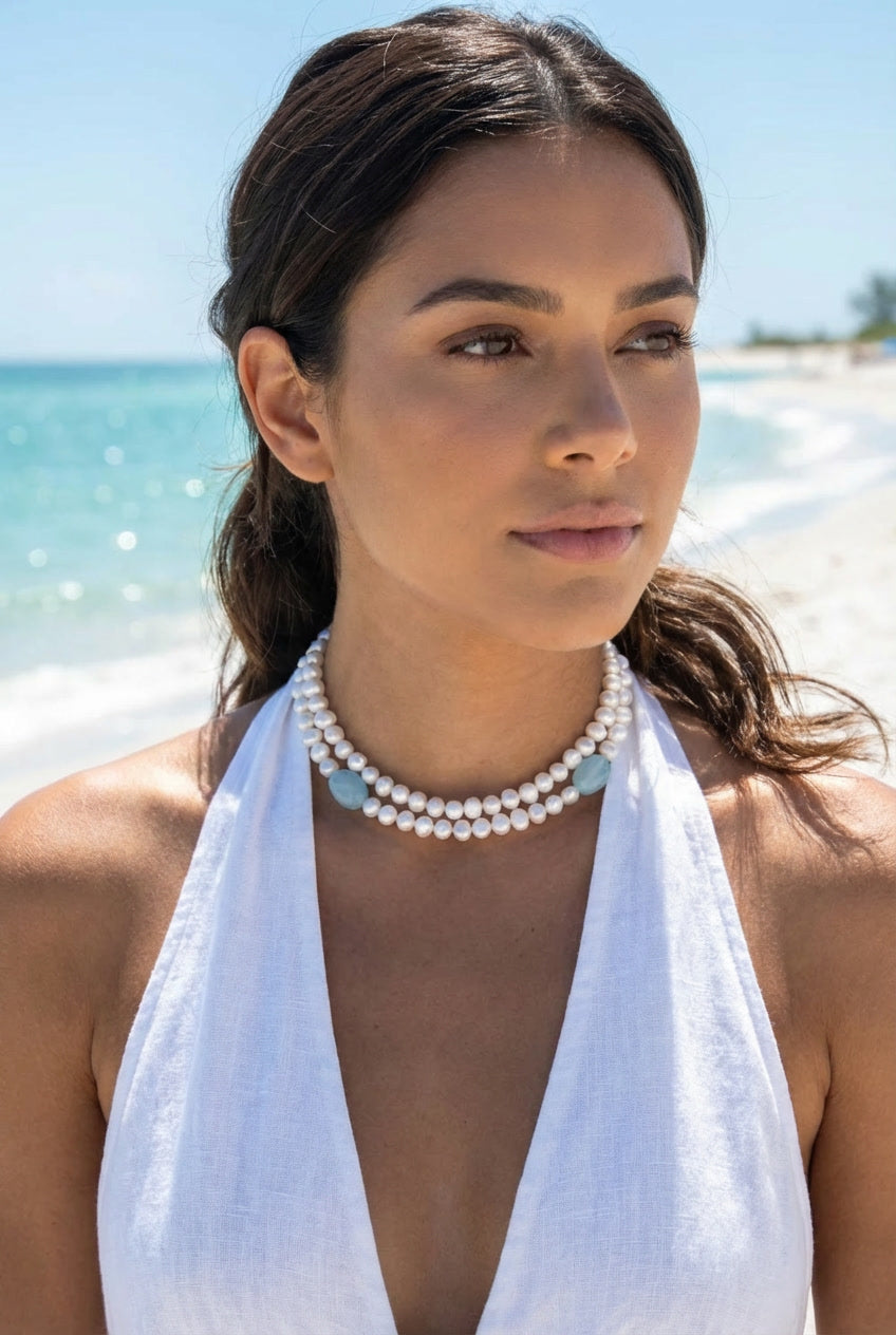 Woman wearing double strand pearl and chalcedony choker on beach in white halter — Lily Frank Jewelry