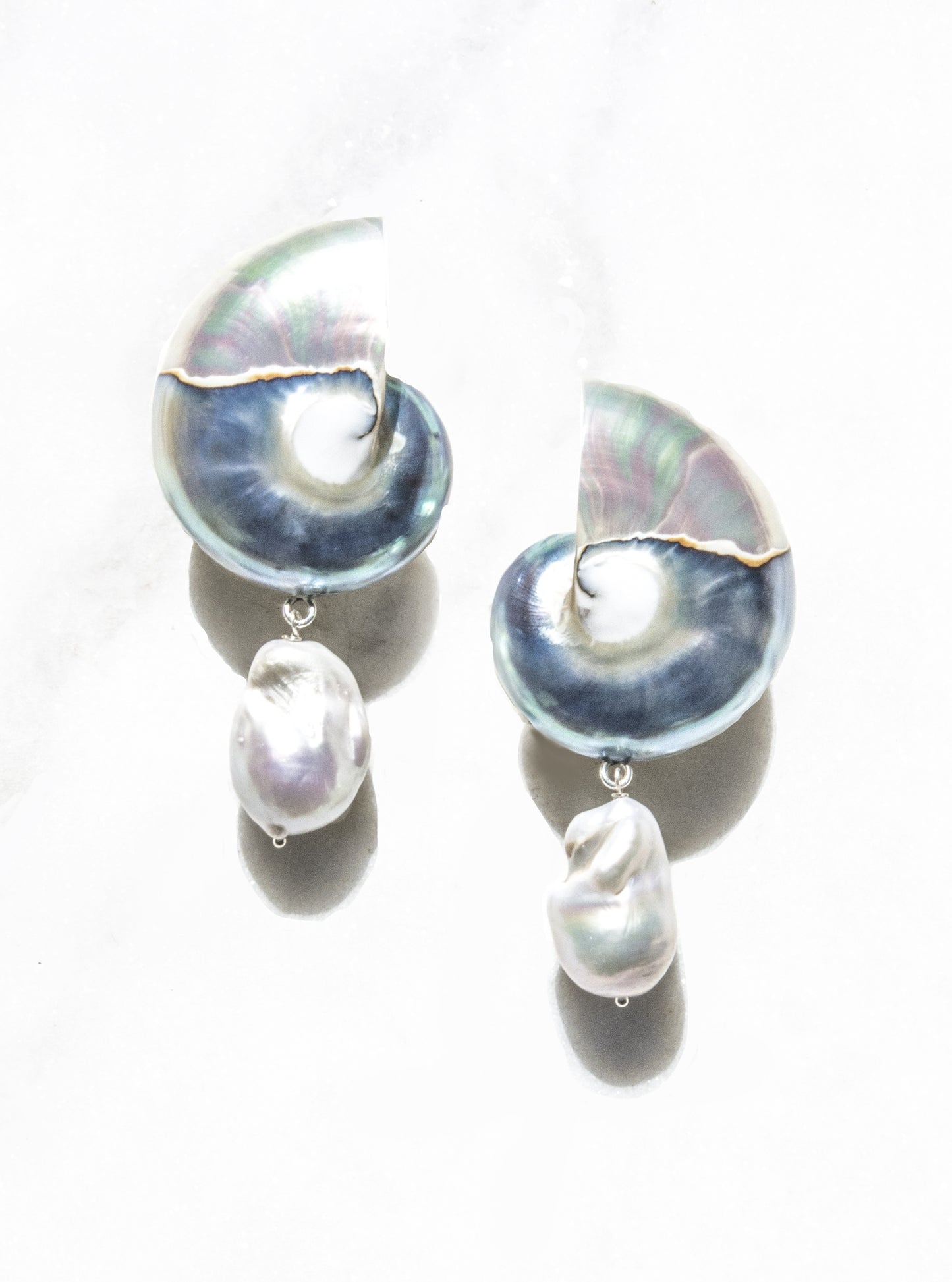 Two-toned nautilus shell drop earrings with baroque pearl drops on white background — Lily Frank Jewelry