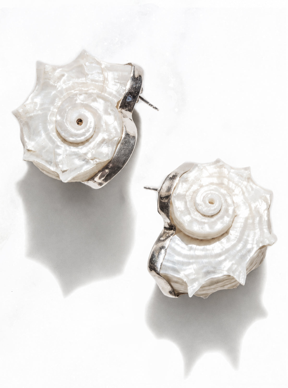 The Betsy dolphin shell earrings with 925 silver on a white marble background | Lily Frank Jewelry 