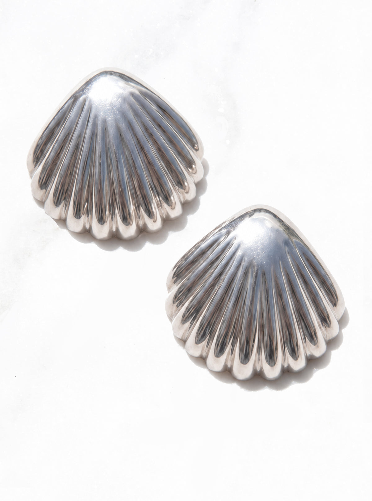 Front view of Large Vintage 925 Silver Scallop Shell Earrings with raised ridges and scalloped edges on white | Lily Frank Jewelry