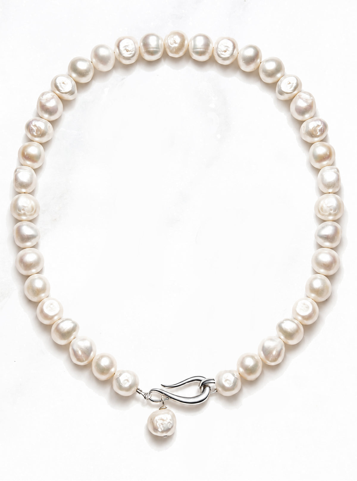 Lindsay Necklace in Freshwater Pearl arranged in a circle on white, with a silver clasp and a single pearl drop | Lily Frank Jewelry