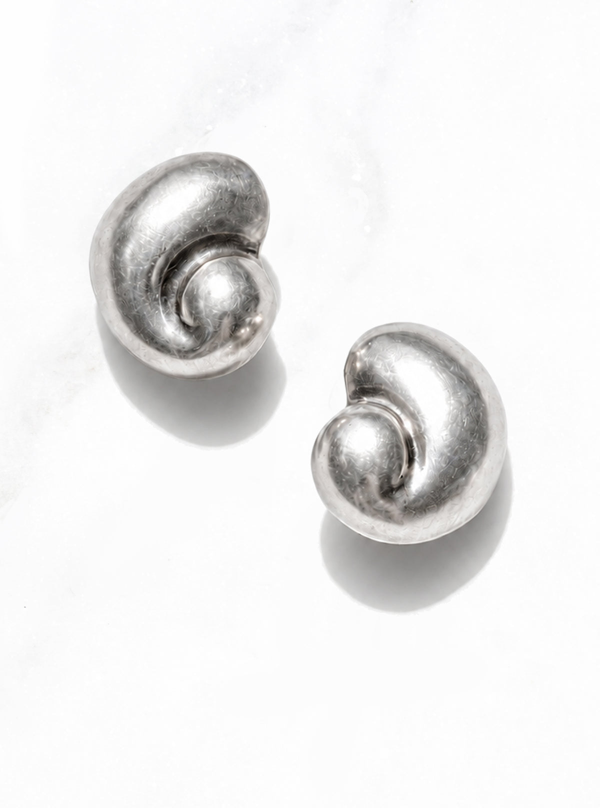 Pair of Vintage 925 Silver Modernist Shell Earrings with sculptural spiral curves on a white background | Lily Frank Jewelry